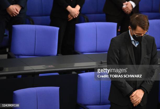 German Health Minister Karl Lauterbach bows his head during a parliament session where he answers questions on October 12, 2022 at the Bundestag, the...