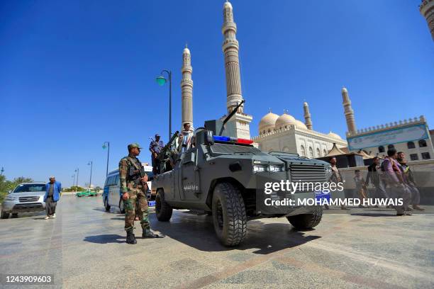 Fighters loyal to Yemen's Huthi rebels march outside al-Saleh grand mosque during a funerary procession for the Huthis' late interior minister...