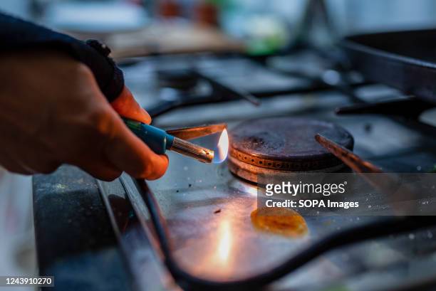 Person lights a gas burner inside a household kitchen in Barcelona. Due to Russia's invasion of Ukraine gas prices have reached record highs in 2022,...