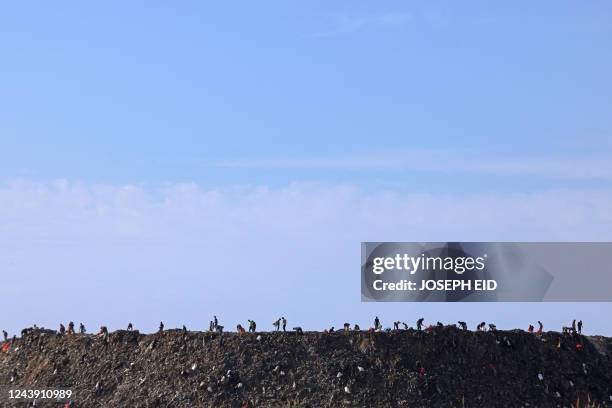 Workers sort out garbage at the landfill of Burj Hammoud, north of the Lebanese capital Beirut, on October 12, 2022.