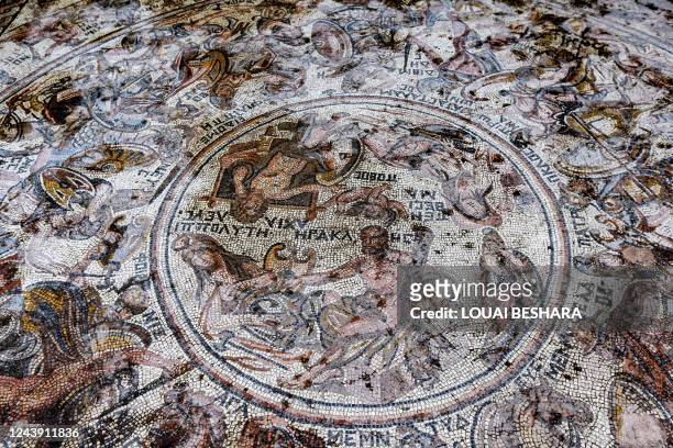This picture taken on October 12, 2022 shows a view of a mosaic floor dating to the Roman era being excavated in the city of al-Rastan in Syria's...