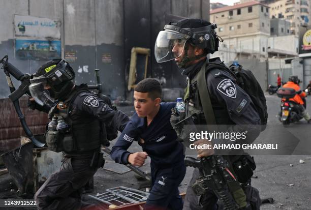Members of the Israeli security forces arrest a young Palestinian protester during confrontations in the Shuafat refugee camp in Israeli-annexed east...