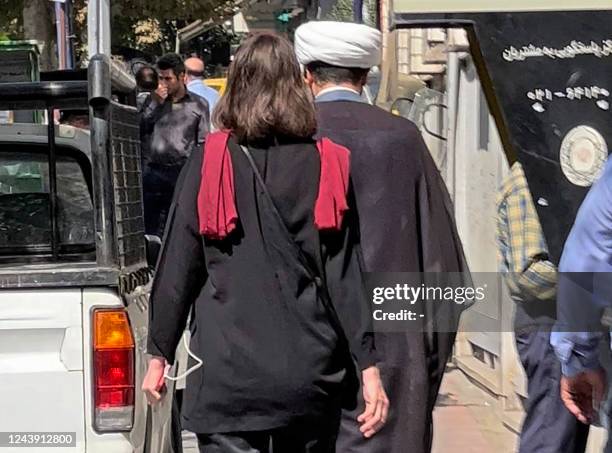 Picture obtained by AFP outside Iran shows a woman walking without a head scarf in the heart of the Iranian capital Tehran, on October 11, 2022. Iran...
