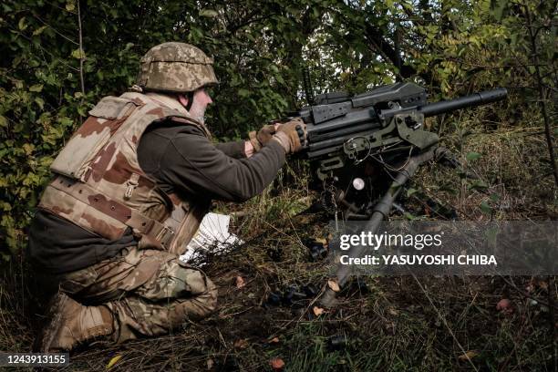 Soldier of Ukraine's 5th Regiment of Assault Infantry fires a US-made MK-19 automatic grenade launcher towards Russian positions in less than 800...