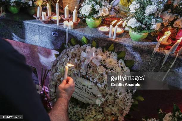Relatives of victims lay flowers in front of Bali Bombing Memorial Monument during the 20th anniversary of the Bali bombings in Kuta, Bali, Indonesia...