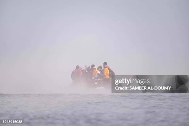 Migrants sail after boarding a smuggler's boat on the beach of Gravelines, near Dunkirk, northern France on October 12 in an attempt to cross the...