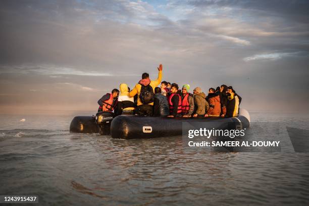 Migrants sail after boarding a smuggler's boat on the beach of Gravelines, near Dunkirk, northern France on October 12 in an attempt to cross the...