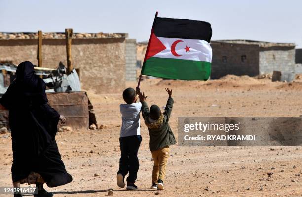 Child raises the flag of the Sahrawi Arab Democratic Republic during celebrations marking the 47th anniversary of the declaration of national unity...