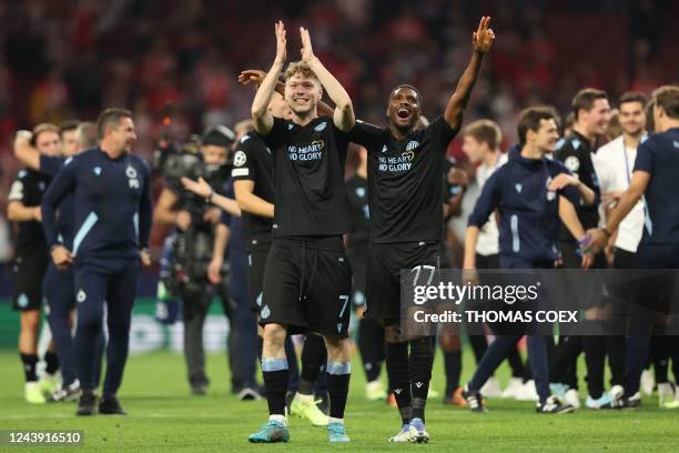 Club Brugge's Danish midfielder Andreas Skov Olsen and Club Brugge's Canadian forward Tajon Buchanan celebrate at the end of the UEFA Champions...