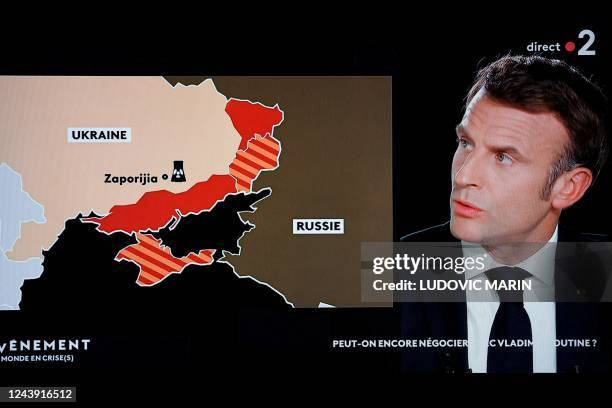 In this screen shot made on Ocober 12, 2022 French president Emmanuel Macron speaks during an interview as part of a new show entitled "L'evenement",...