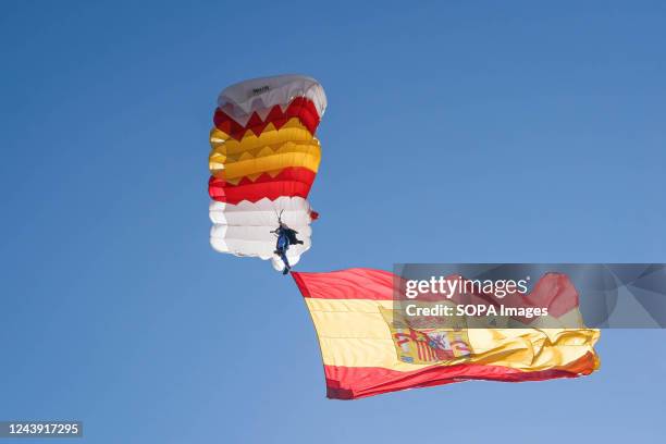 Military paratrooper with the flag of Spain seen during the Hispanic Day parade in Paseo de la Castellana, Madrid. Spain celebrates its national...