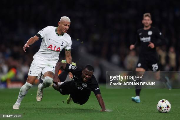 Tottenham Hotspur's Brazilian striker Richarlison fights for the ball with Frankfurt's French defender Evan N'Dicka during the UEFA Champions League...