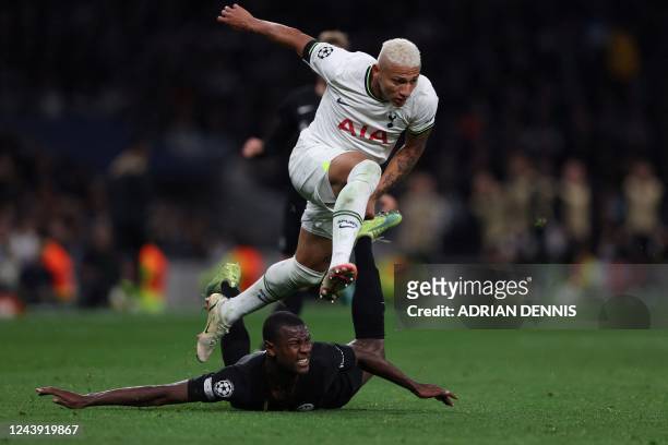 Tottenham Hotspur's Brazilian striker Richarlison jumps over Frankfurt's French defender Evan N'Dicka during the UEFA Champions League Group D...