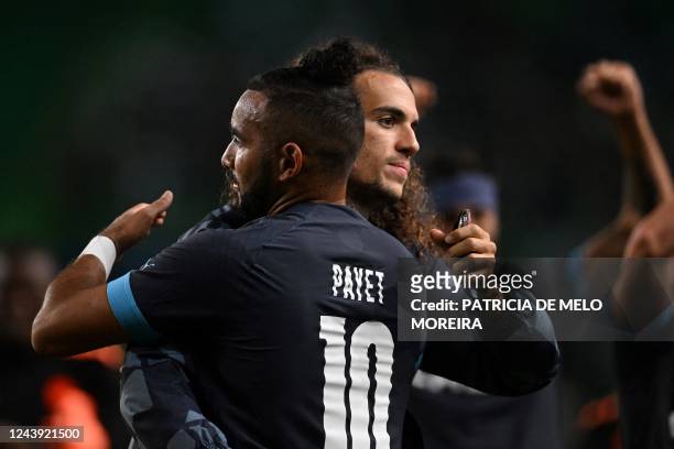 Marseille's French midfielder Matteo Guendouzi celebrates with Marseille's French midfielder Dimitri Payet at the end of the UEFA Champions League...