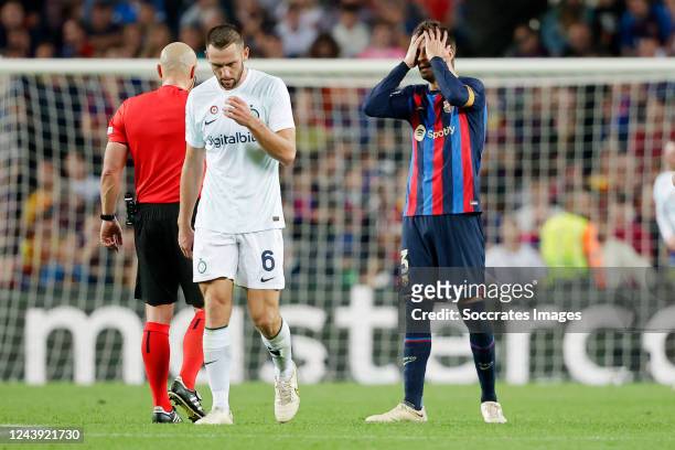 Stefan de Vrij of FC Internazionale Gerard Pique of FC Barcelona disappointed during the UEFA Champions League match between FC Barcelona v...