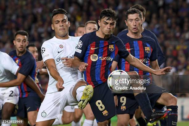 Inter forward Lautaro Martinez vies with Barcelona's Spanish midfielder Pedri during the UEFA Champions league football match between FC Barcelona vs...