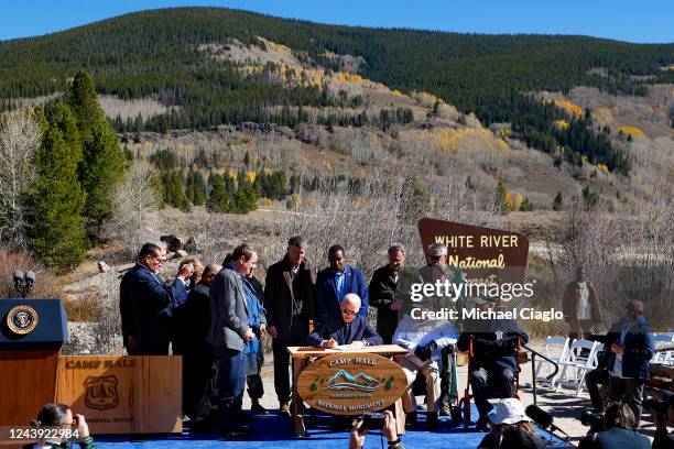 President Joe Biden, surrounded by Sen. Michael Bennett , Sen. John Hickenlooper , U.S. Rep. Joe Neguse , White River National Forest supervisor...