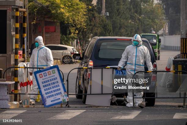 Workers wearing personal protective gear at an area placed under lockdown due to Covid-19 in Beijing, China, on Wednesday, Oct. 12, 2022. Chinese...