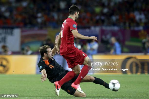 Joris Mathijsen of Holland, Joao Pereira of Portugal during the EURO match between Portugal v Holland on June 17, 2012