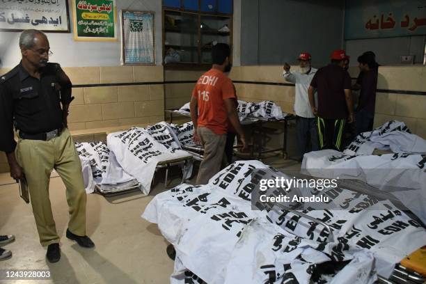 View of the bodies of those who burned to death on the bus in Karachi, Pakistan on October 13, 2022. At least 18 people, including 8 children, were...