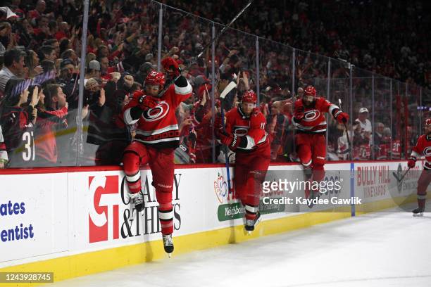 Jordan Martinook, Jordan Staal, and Brent Burns of the Carolina Hurricanes participate in the Storm Surge after winning against the Columbus Blue...