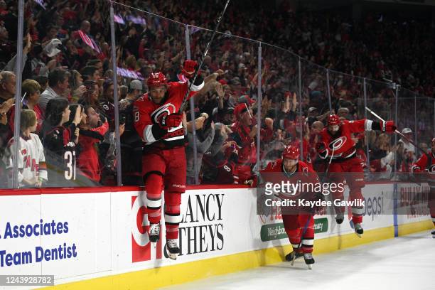 Jordan Martinook, Jordan Staal, and Brent Burns of the Carolina Hurricanes participate in the Storm Surge after winning against the Columbus Blue...