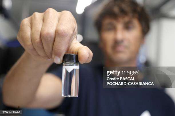 Nomado company technical director Karim Kenzi checks drinkable water after passing through the filtering system of a desalination plant at Macinaggio...