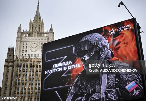 Russian Foreign Ministry building is seen behind a social advertisement billboard showing Z letters - a tactical insignia of Russian troops in...