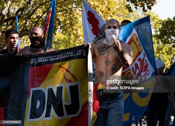 Group of Nazi sympathizers expresses their opinion at a demonstration during the National Day of Spain. Dozens of far-right supporters gathered and...