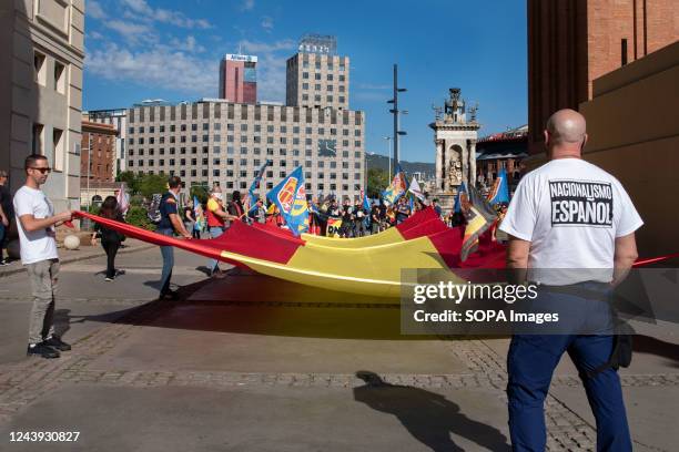 Spanish far-right demonstrators hold a huge Spanish flag to celebrate the National Day of Spain at the Plaza España. Dozens of far-right supporters...