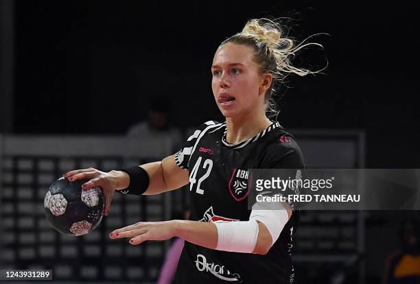 Brest's centre back Jenny Carlson passes the ball during the handball match between Brest and Plan-de-Cuques as part of the women's French...