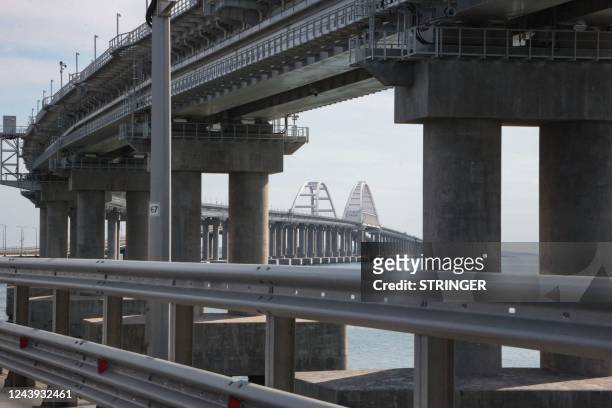 This picture taken on October 13, 2022 shows the Kerch Bridge that links Crimea to Russia, which was hit by a blast on October 8, 2022. - The...