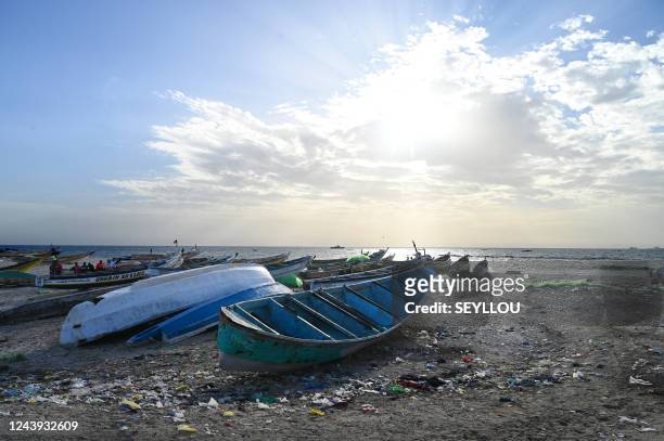 This photograph taken on October 10 shows dugout canoes on the beach of Gokhou Mbath, near a platform under construction for the exploitation of an...