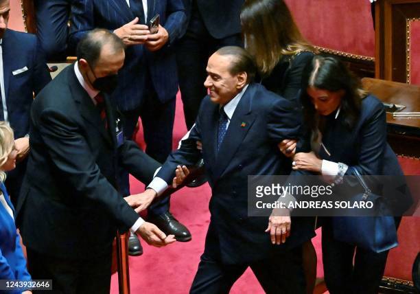 Leader of the Italian right-wing party "Forza Italia" , Silvio Berlusconi is helped during the vote for the new president of the Senate following the...