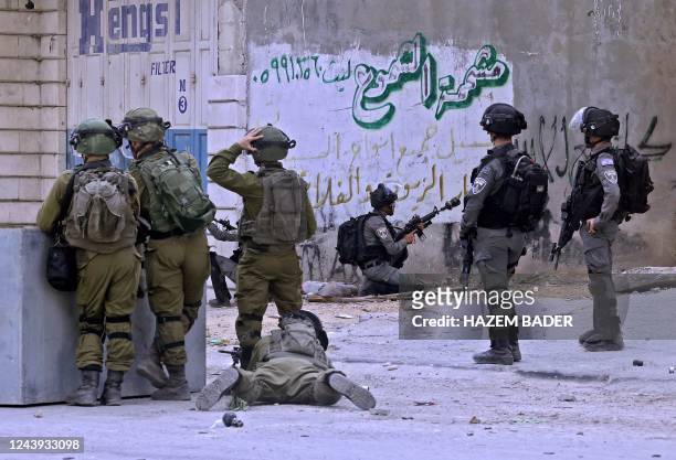 Graphic content / Israeli security forces on October 13 take position at the entrance of al-Aroub refugee camp near the occupied West Bank city of...