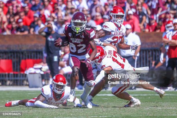 Mississippi State Bulldogs wide receiver Rufus Harvey runs away from Arkansas defenders during the game between the Mississippi State Bulldogs and...