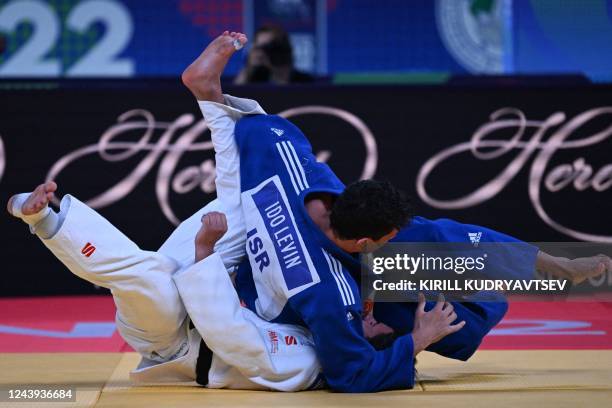 Netherlands' Ivo Verhorstert and Israel's Ido Levin compete in the bronze medal contest of the mixed teams event at the 2022 World Judo Championships...