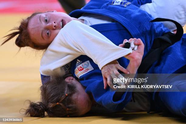 Netherlands' Sanne Vermeer and Israel's Maya Goshen compete in the bronze medal contest of the mixed teams event at the 2022 World Judo Championships...