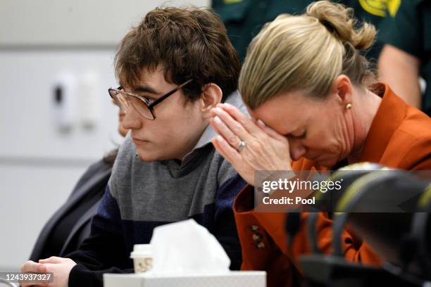 Assistant Public Defender Melisa McNeill, seated with Marjory Stoneman Douglas High School shooter Nikolas Cruz touches her hands to her head as the...