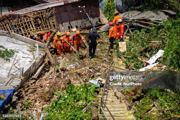 Indonesian Rescuer search for victims of landslides that swept away homes due heavy rainfall at a village in Bogor City, West Java, Indonesia on...