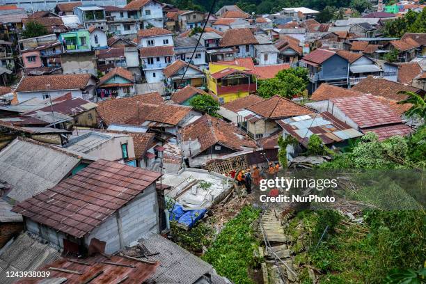 Indonesian Rescuer search for victims of landslides that swept away homes due heavy rainfall at a village in Bogor City, West Java, Indonesia on...