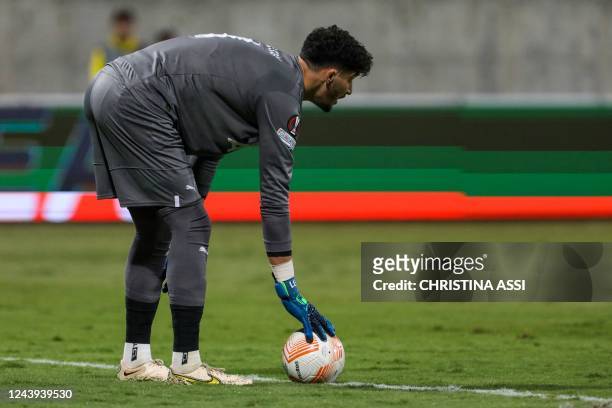 Fenerbahce's Turkish goalkeeper Altay Bayindir places the ball during the UEFA Europa League group B football match between Cyprus' AEK Larnaca and...