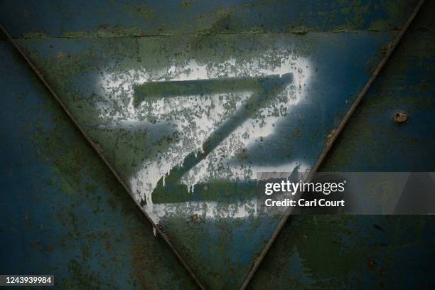 Russian 'Z' military symbol is pictured on a garage door in a compound used by Russian military as a barracks and local headquarters, on October 13,...