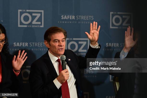 Republican U.S. Senate candidate Dr. Mehmet Oz raises his hand during a safer streets community discussion at Galdos Catering and Entertainment on...