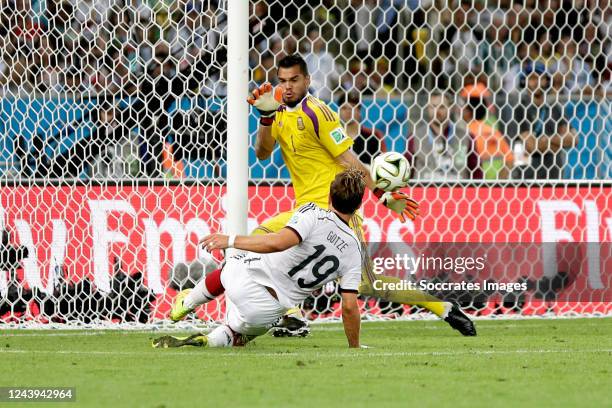 Mario Gotze of Germany scores the first an winning goal goal to make it 0-1 against Sergio Romero of Argentina during the World Cup match between...