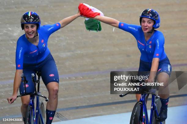 Italy's Vittoria Guazzini and Italy's Chiara Consonni celebrate their team's victory with the Italian national flag after winning the Women's Team...