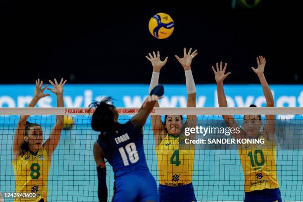 Brazil players Fernanda Silva Carneiro Macris, Ana Carolina Da Silva and Gabriela Braga Guimaraes defend against Paola Ogechi Egonu of Italy during...
