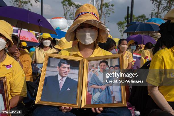 Thai royalist supporter holds the portrait of Thai King Maha Vajiralongkorn and Thai Queen Suthida, during the 6th death anniversary of the late Thai...