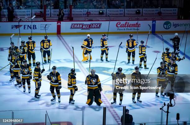 Pittsburgh Penguins salute the fans at center ice before the NHL game between the Pittsburgh Penguins and the Arizona Coyotes on October 13 at PPG...