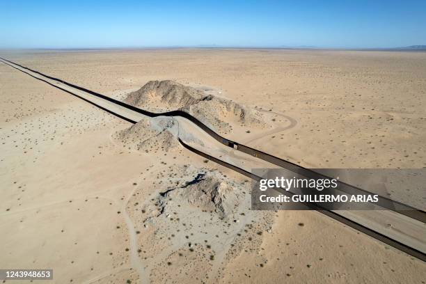 Aerial view of a hill on the dessert crossed by a section of the US - Mexico border wall near San Luis Rio Colorado, Mexico, on September 19, 2022....